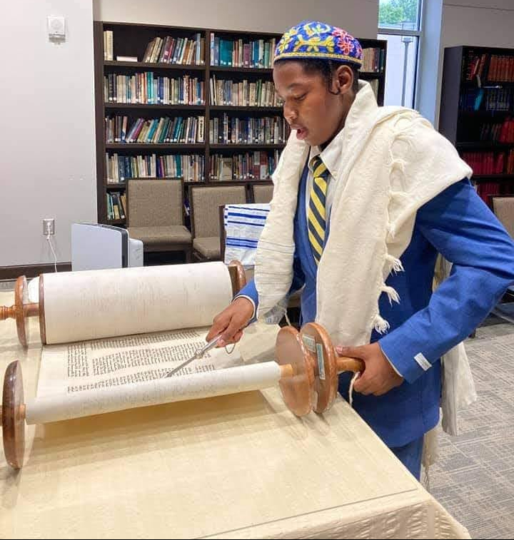Standing at the Bimah reading Torah during a Bar Mitzvah